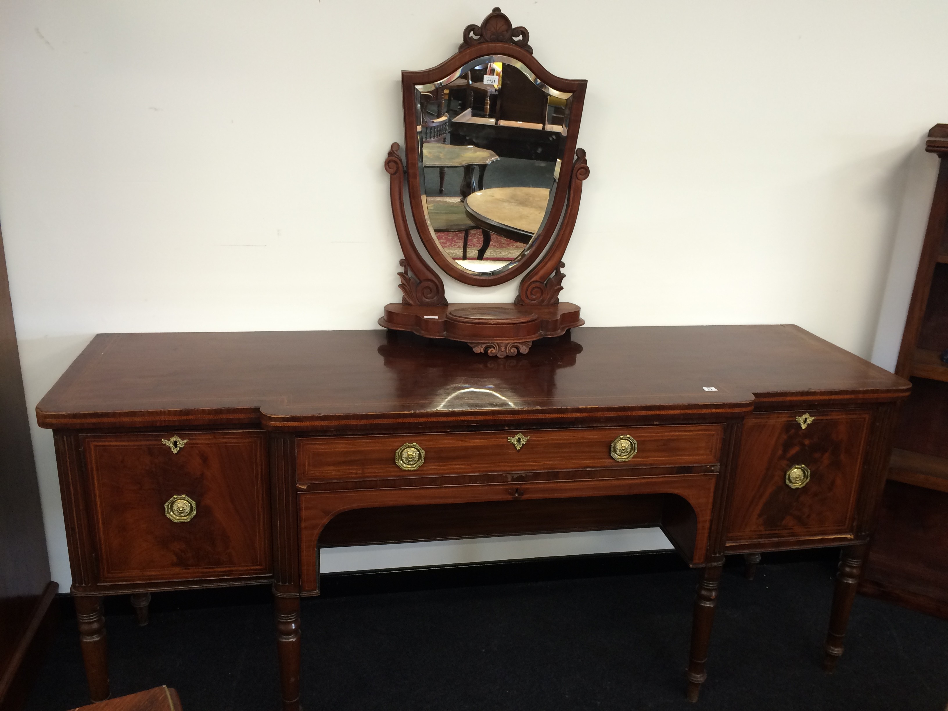 A George III mahogany breakfront sideboard with centre dummy frieze drawer and cellaret drawer with