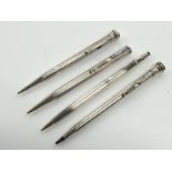 A silver Caran D'ache propelling pencil together with three other silver cased propelling pencils.