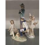 A collection of three Lladro china figures: Boy and girl on seesaw,