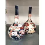 A pair of bottle shaped Imari vases.