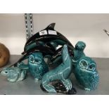 A set of three Graduated Poole Pottery blue glazed dolphins together with a collection of other