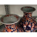 A pair of Japanese Imari vases (one rim af).