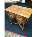 A Charles II reproduction oak single drawer side table resting on turned column supports.