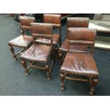 A set of five oak and leather back Cromwellian dining chairs.