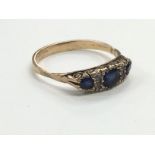 A 9 carat gold blue and white stone set ladies dress ring.