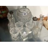 A set of four glass salts on square bases together with other heavy cut glass items and bottles.