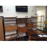 A Staples Ladderax "L" shaped sectional shelving display comprising modular cabinets,