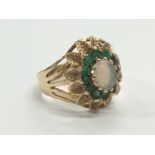 A 9 carat gold opal and emerald ring (size O).