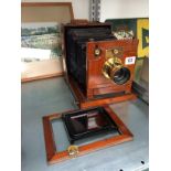 A Victorian mahogany cased folding camera with brass fittings and gilded brass lens