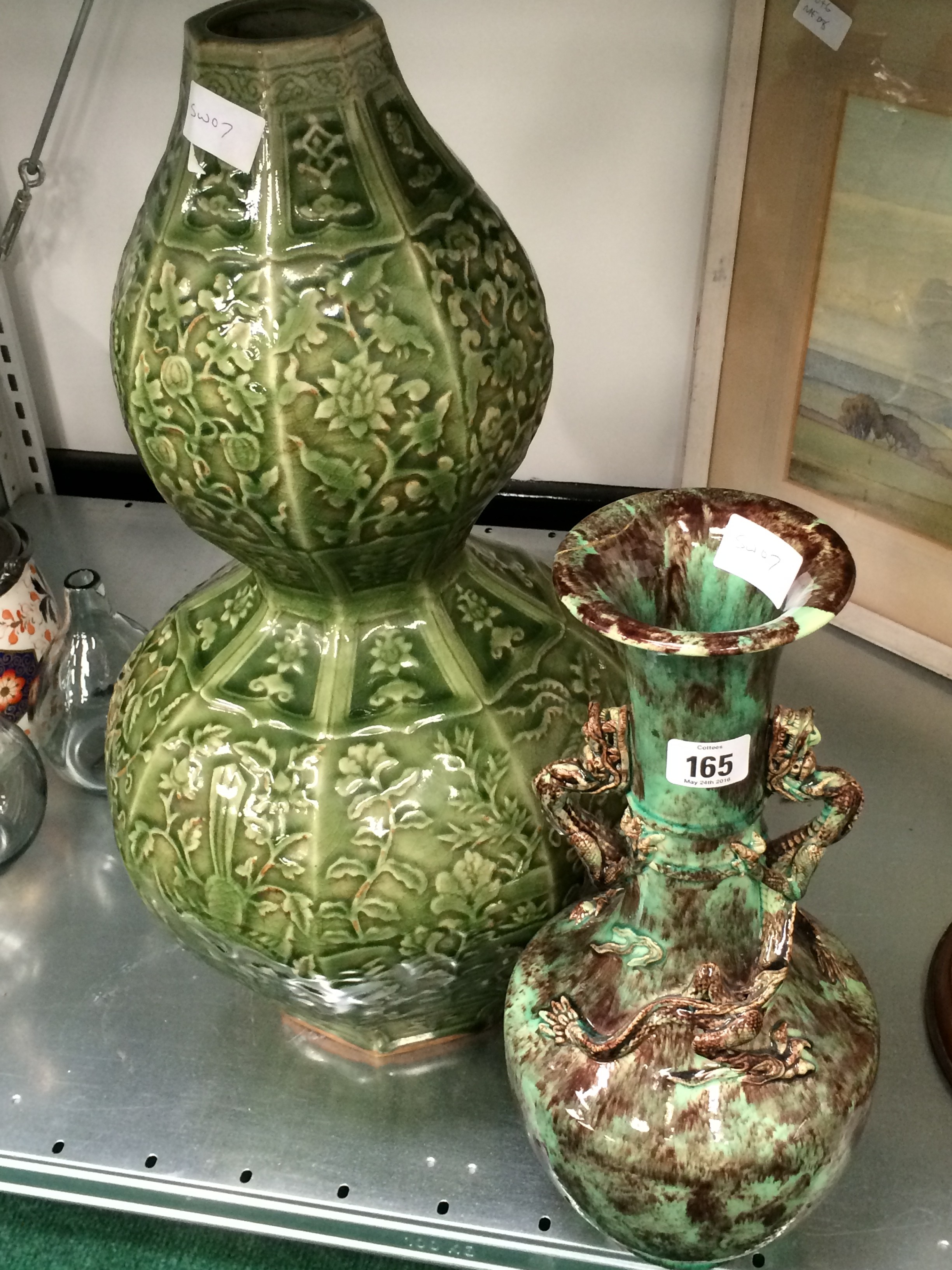 A large Oriental earthenware green glazed gourd shape vase with floral decoration together with a