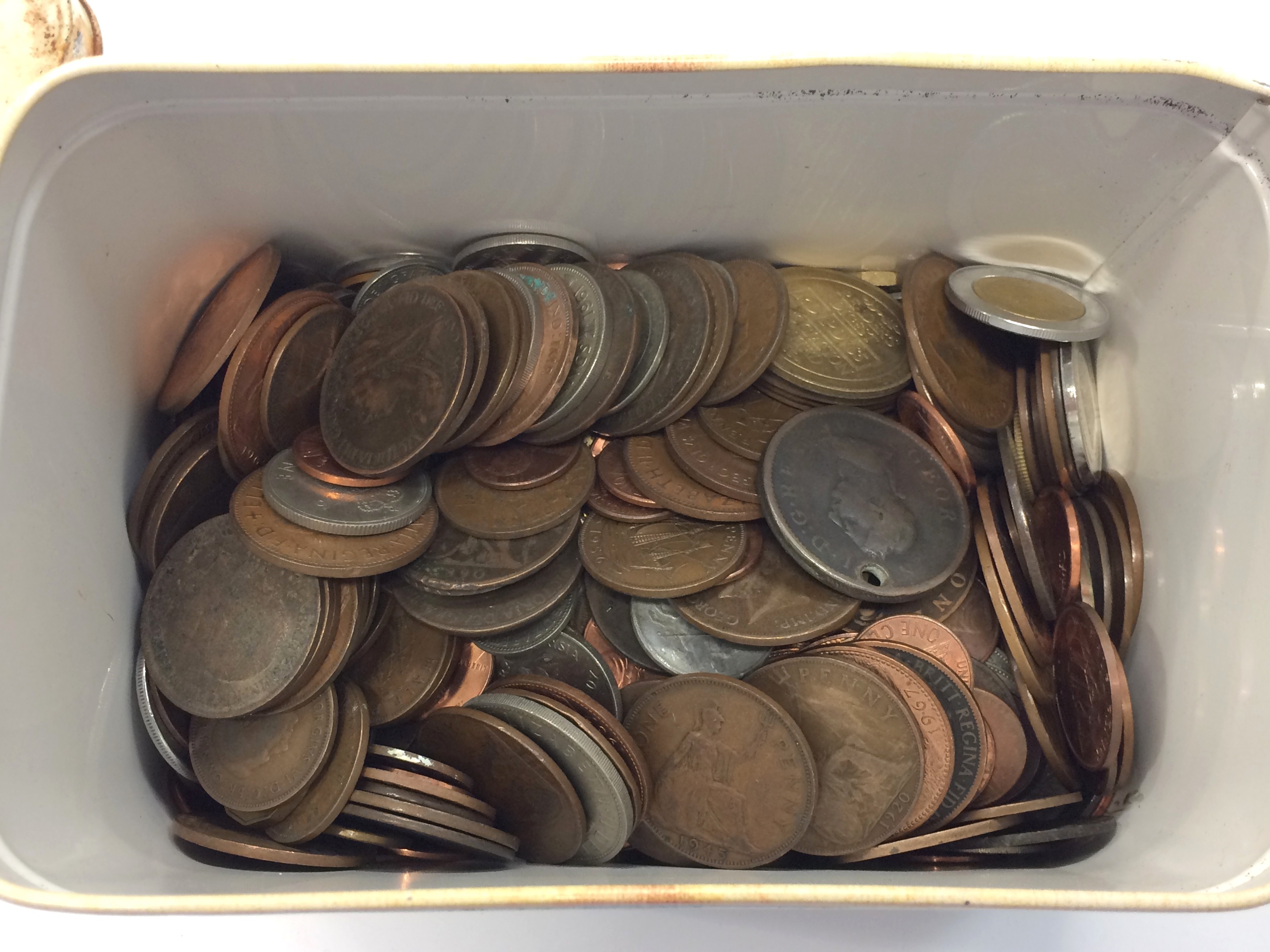 A tin of various coins.