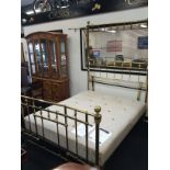 A large Victorian brass quarter canopy bed to include cast iron frame and mattress.