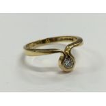 An 18 carat gold single diamond set designer abstract ring (size K1/4).