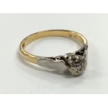 An 18 carat gold small diamond solitaire ring.