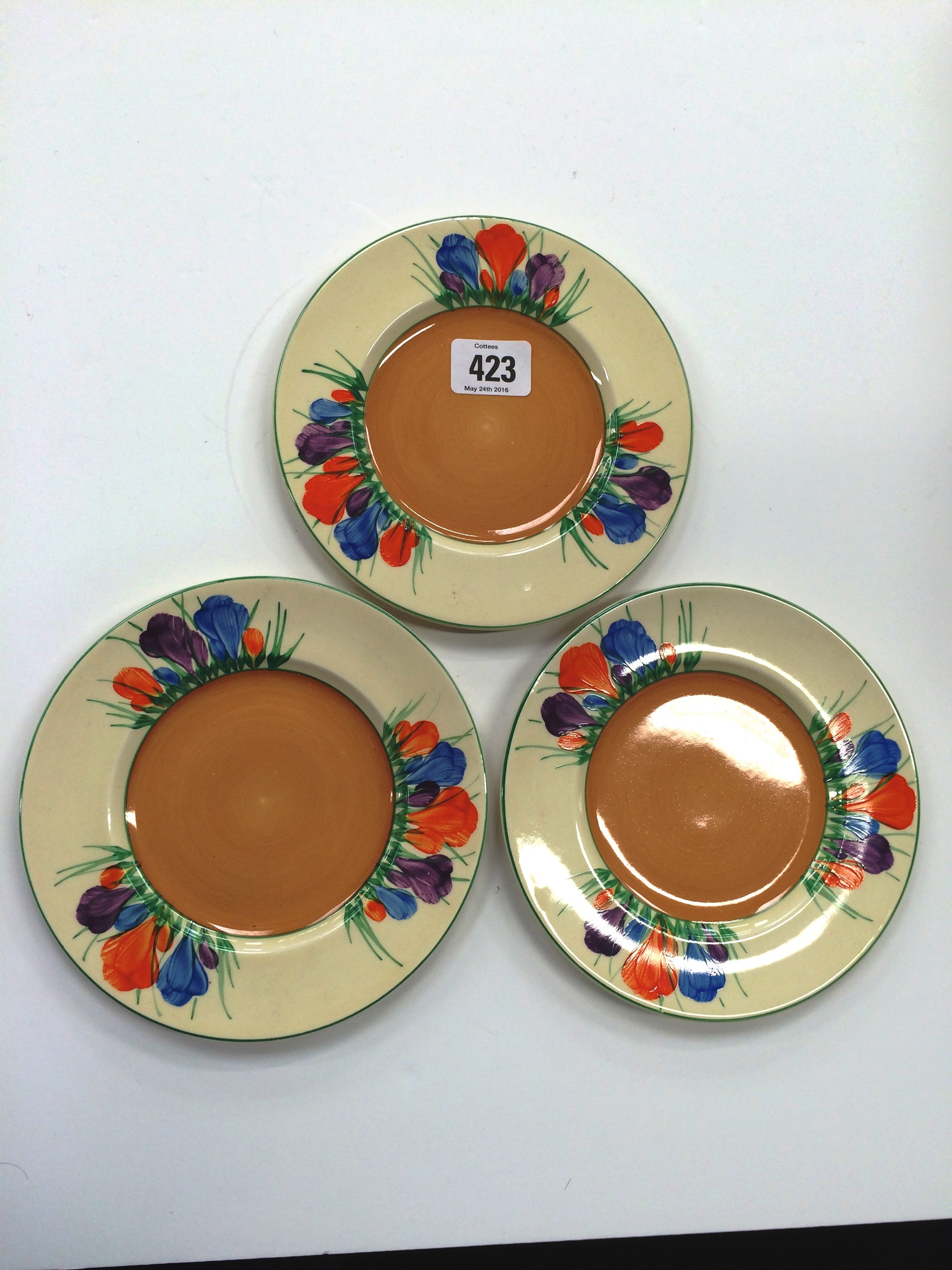 Three Clarice Cliff Royal Staffordshire Ceramics side plates, decorated in the Crocus pattern.