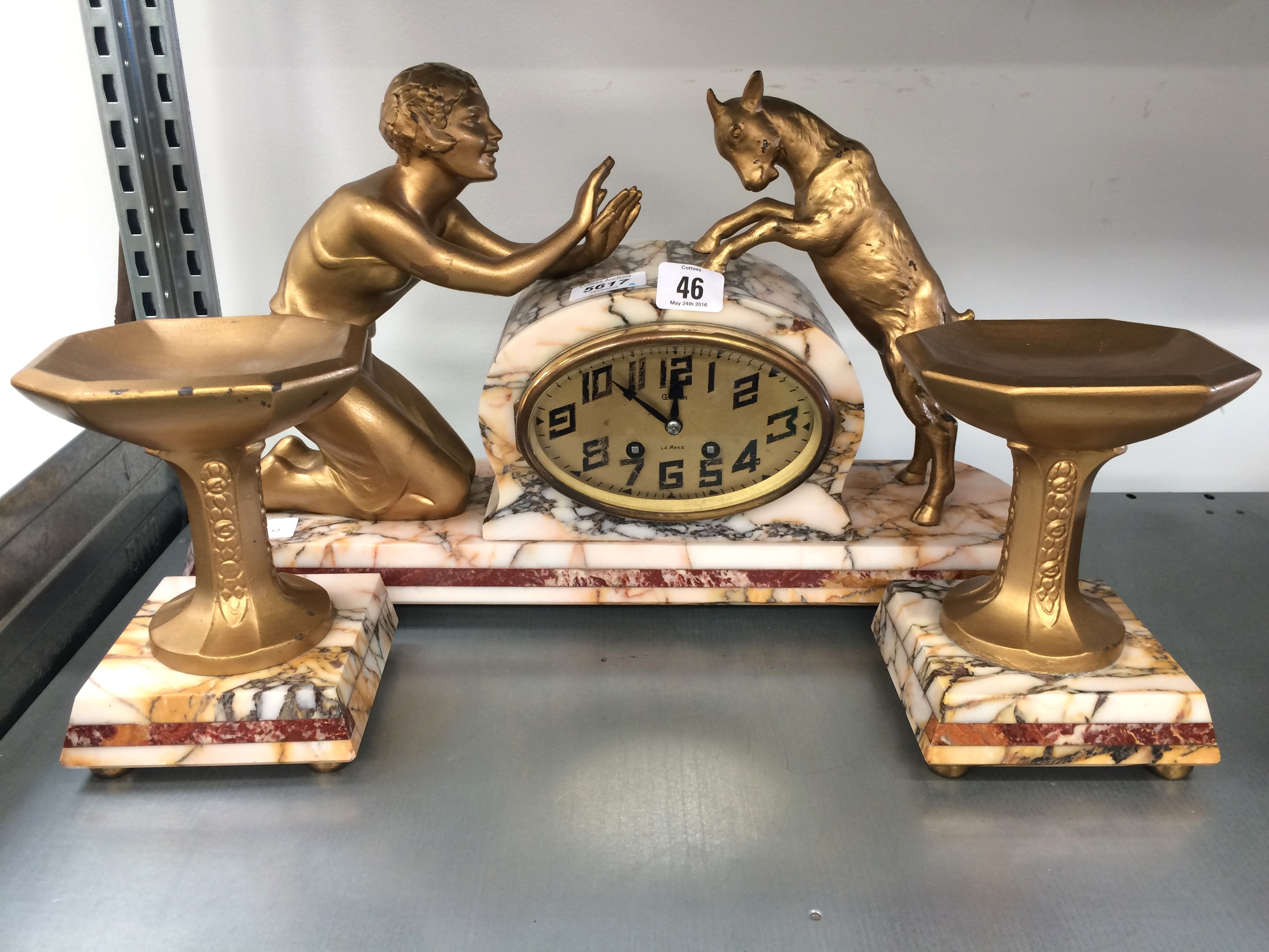 A French 1930's marble mantle clock with side vases depicting a young girl and a goat.