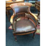 A Victorian aesthetic mahogany reading chair, U shaped rexine covered back,