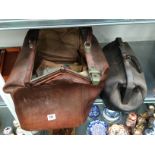 A large brown leather Gladstone bag together with a small black leather Doctor's bag.