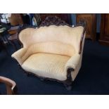 A Victorian mahogany two seater sofa, all over carved mahogany back, carved mahogany front,