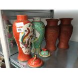 A Cantonese enamelled bulbous green glazed vase decorated with a lady in garden setting,