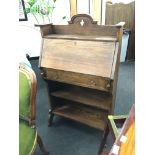 An Edwardian oak drop-flap writing desk fitted single drawer and open base.