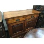 A carved oak late 19th century sideboard with brass handles, 4'.