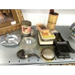 A collection of smoking related items including advertising ashtray,