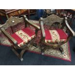 A pair of beech framed BurgerMeister chairs on cross framed stretchers with tapestry seats.