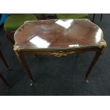 A French Amaranth and mahogany inlaid topped coffee table with brass edge,