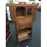 An Edwardian oak Art Nouveau bureau bookcase with metal mounts, four down front,