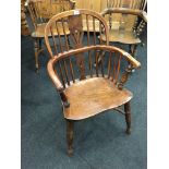 A Victorian Windsor chair in elm and fruitwood, turned front legs and Crinoline base.