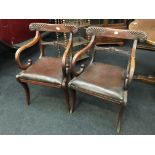 A pair of Regency mahogany Trafalgar design elbow chairs with swan necked arms and gadrooned