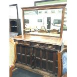 A Victorian oak sideboard fitted with a mirrored back, ebony and oak crossed panels,