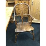 A late 19th century wheelback Windsor armchair resting on turned front legs and Crinoline base.