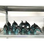 Eleven various blue glazed Poole Pottery dolphins.