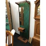 A 1950's teak and rexine backed hallstand with sidetable and umbrella rack.