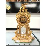 A gilt metal 19th century mantle clock with bird surmount resting on pillar supports (no movement).