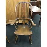 A Victorian splat back and turned wood Windsor rocking chair with turned gallery and legs.