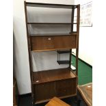 A 1960's wall unit divider fitted with sliding cupboards and drawers and cabinet.