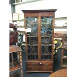 A Chippendale inspired glass fronted astragal glazed display cabinet with fret cut cornice and