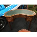 An Edwardian design kidney shaped writing desk with leather and gilt tooled inlaid centre,