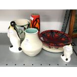 A collection of various Poole pottery items including two Penguins and an Exodus pattern dish.