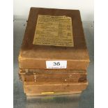 Four boxes containing a collection of glass photographic plates depicting the construction of