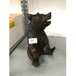 A small carved wood tobacco jar in the Bavarian style modelled as a seated bear.