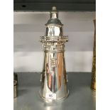 A large silver plated Lighthouse cocktail shaker.