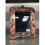 An Art Nouveau style copper and enamel photograph frame.