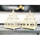 A pair of cream painted small Wedding Cake shape bird cages.