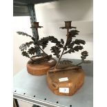 A pair of Arts & Crafts style copper candlesticks modelled as Oak Trees on circular oak wooden