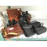 A pair of Denhill binoculars together with a pair of Karl Zeiss Genoptem 8 x 30 binoculars in