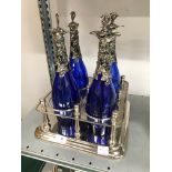 Four blue bottle decanter stand.